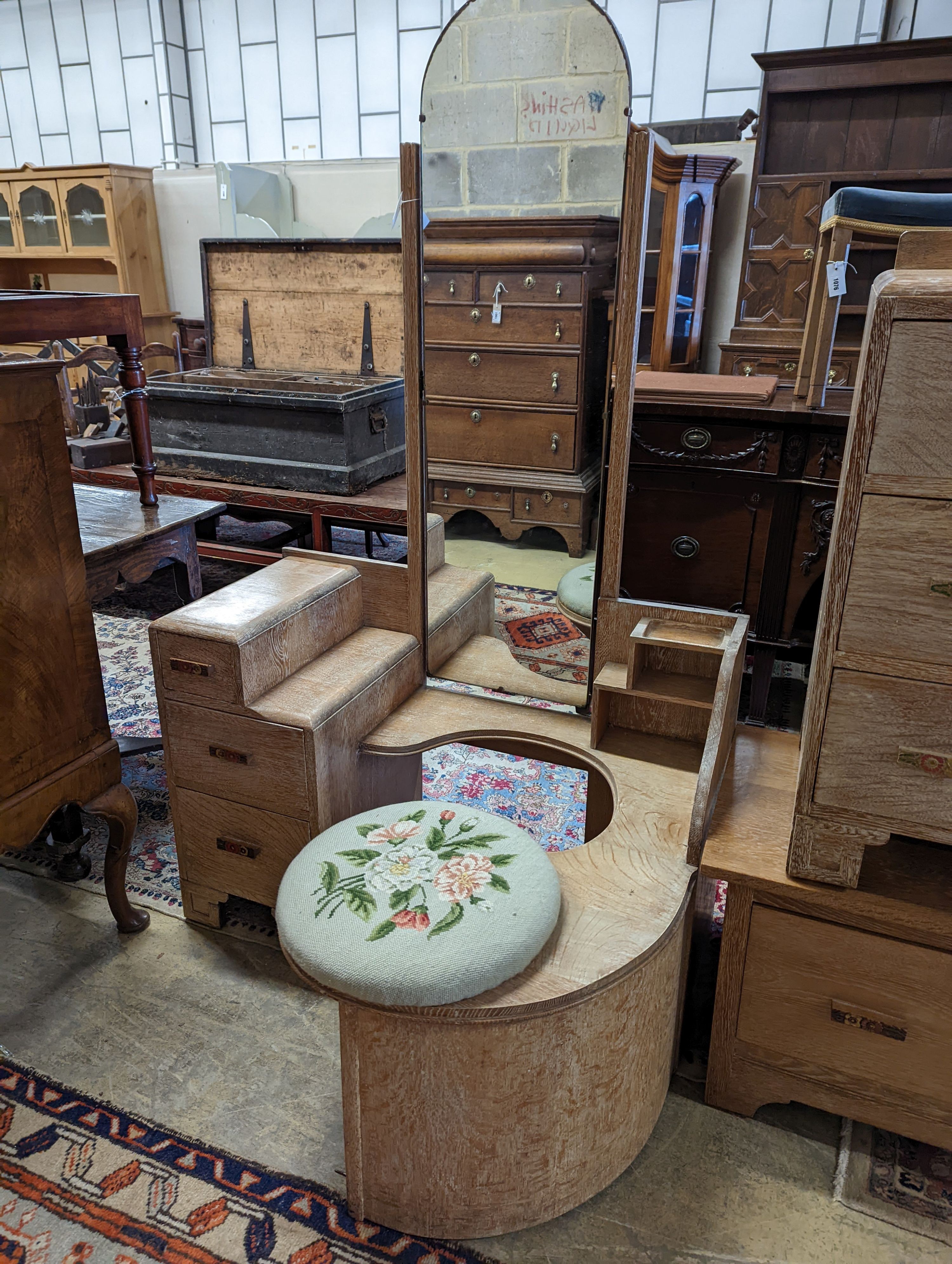 An Art Deco style limed oak three piece bedroom suite and a similar low chest, wardrobe width 108cm depth 51cm height 185cm